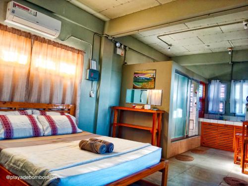 a bedroom with two beds in a room at Playa de Bombora Inn in Cabugao