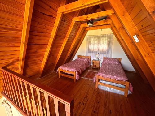 En eller flere senge i et værelse på Chalet Alpino en las Sierras