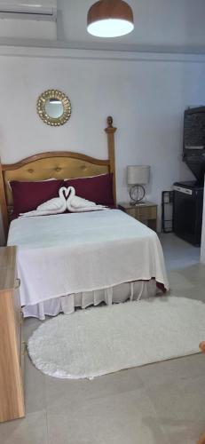 a bedroom with a bed with a white bedspread at Martha's House Kia in Soufrière