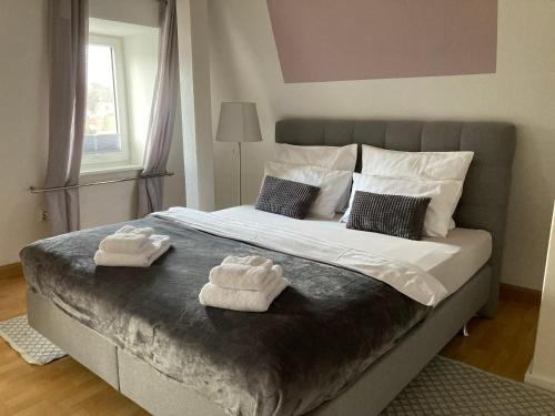 a bedroom with a large bed with towels on it at Villa Schlossblick I - Zeit zum Entspannen in exklusiver Ferienwohnung mit Panoramablick, Parkplatz, WLAN, Smart-TV in Wernigerode