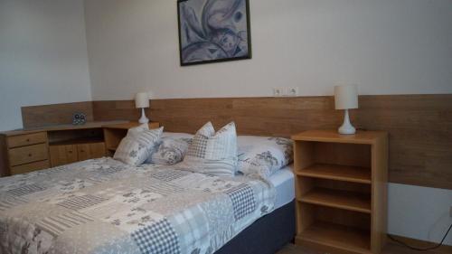a bedroom with a bed with two night stands and two lamps at Apartment 24 modern & gemütlich in Dessau