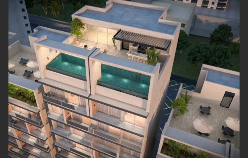 an overhead view of a building with a swimming pool at HABITACIÓN Torres Palmas alberca, vista al mar, Roof Top VIP in Boca del Río