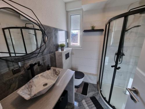 a bathroom with a sink and a shower at Apartman Lipik in Lipik