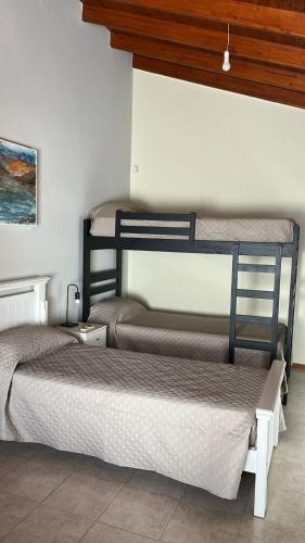 a room with two bunk beds in a room at Shakti in Almafuerte