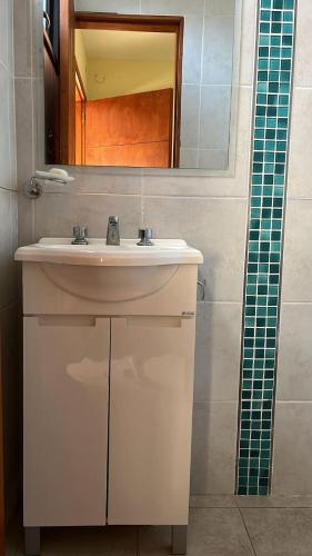 a bathroom with a white sink and a mirror at Shakti in Almafuerte