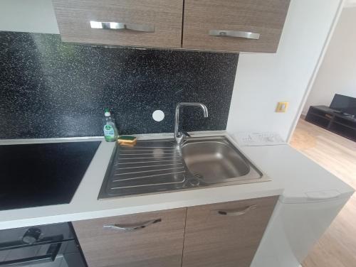 a kitchen with a sink and a stove at T2 Cosy 20 min Paris in Bezons