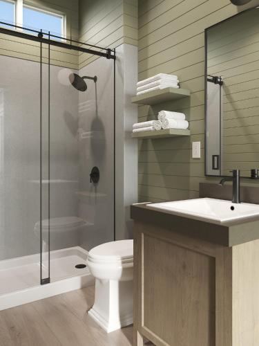 a bathroom with a shower and a toilet and a sink at Outbound Yosemite in Oakhurst