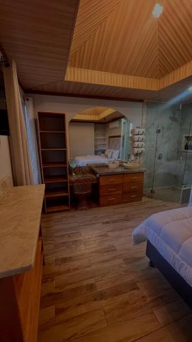a bedroom with a bed and a large mirror at Arenal Stone House in Ángeles