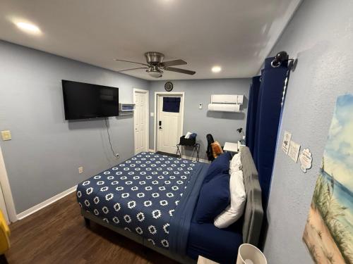 a bedroom with a bed and a flat screen tv at Signature Suite in Orlando