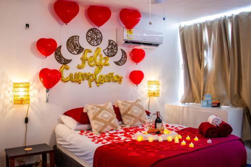 a room with a bed with hearts and a happy anniversary sign at Apto Diners Rodadero WiFi - Piscina - Playa in Rodadero