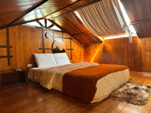 een slaapkamer met een groot bed in een kamer bij La Cabaña de Ciela C glamping con jacuzzi , minigolf y croquet in Latacunga