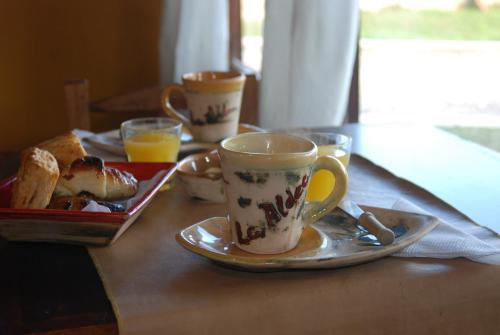 a table with a coffee cup and a tray of food at La Aldea in San Rafael