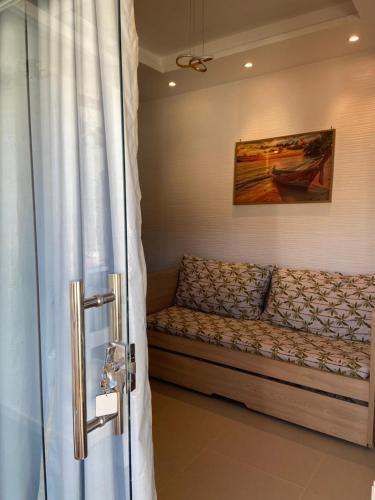 a couch in a room with a painting on the wall at Flat Sétima Arte in Cairu