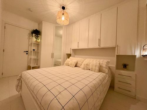 a bedroom with a large bed with white cabinets at BEACH apartment met directe toegang tot het STRAND ! in Knokke-Heist