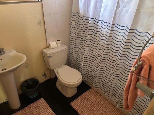 a bathroom with a toilet and a sink at 3Dives Cliffside Rooms in Westlands