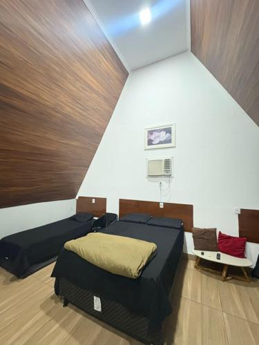 a bedroom with two beds and a basketball hoop at In concept chalé completo in Duque de Caxias