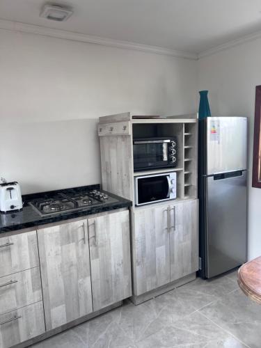 a kitchen with stainless steel appliances and a refrigerator at Casa Maly, valle de apalta, Santa Cruz in Santa Cruz