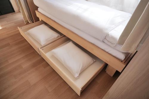 a bunk bed with two white pillows on it at Petit Grande Nuage in Tokyo
