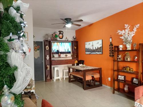 a living room with a table and a christmas tree at Casa Adhita, tú confort es nuestra prioridad. in Yautepec de Zaragoza