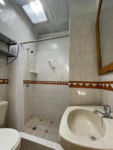 a bathroom with a sink and a toilet at Hostal Lluvia de Oro in Arequipa