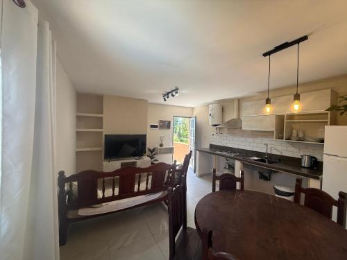 a kitchen with a table and a dining room at La catalina in San Antonio