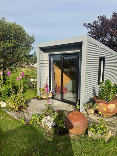 a small shed with plants in a garden at Harbourview Hideaway in Riverton