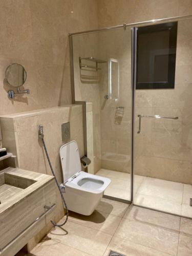 a bathroom with a shower and a toilet and a sink at فندق هوتيلتن HotelTen in Riyadh