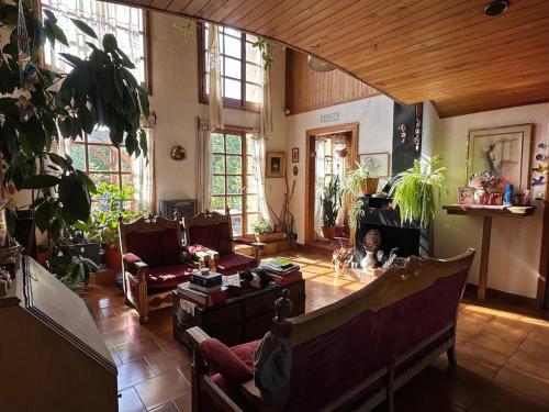 a living room with a couch and a fireplace at Posada del Buscador in El Bolsón