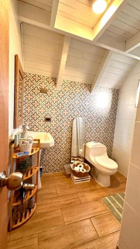 a bathroom with a toilet and a sink at Cabañas RyL Aeropuerto 1 in Puerto Montt