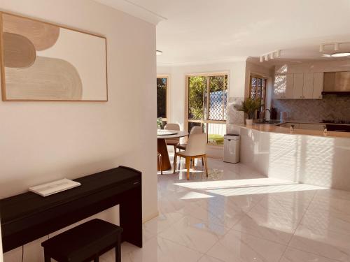a kitchen and living room with a table and a counter at Carindale family home, private pool, leisure accommodation in Brisbane