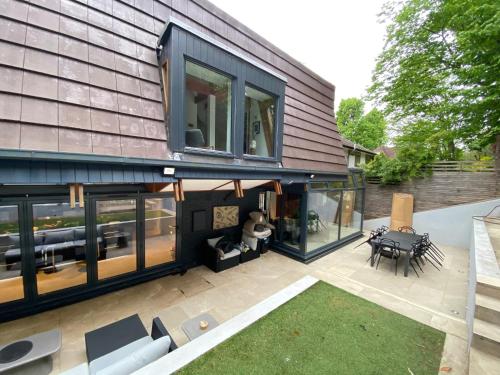 a house with a large window and a patio at Luxury Double Room in Chislehurst