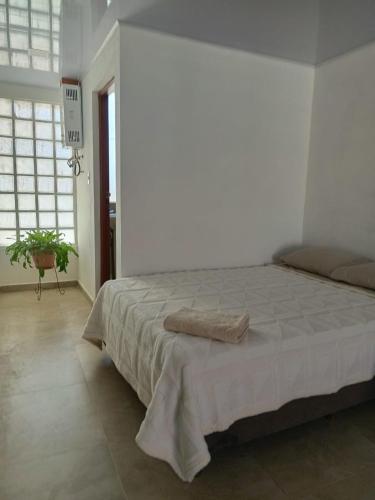 a bedroom with a large bed in a room with windows at Mi casa en Sucre in Sucre
