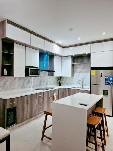 a kitchen with a white counter and wooden cabinets at casa estefania in San Carlos