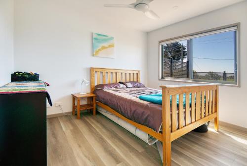 a bedroom with a bed and a large window at Lees Dream in Venus Bay