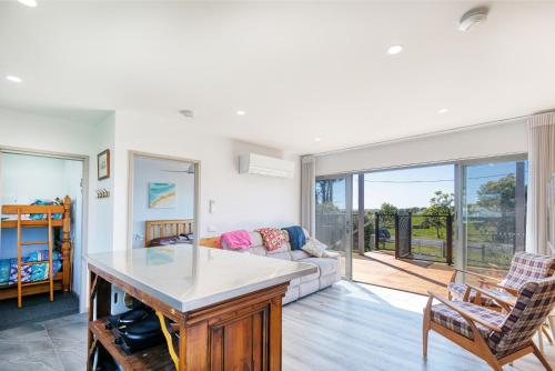 a living room with a couch and a table at Lees Dream in Venus Bay