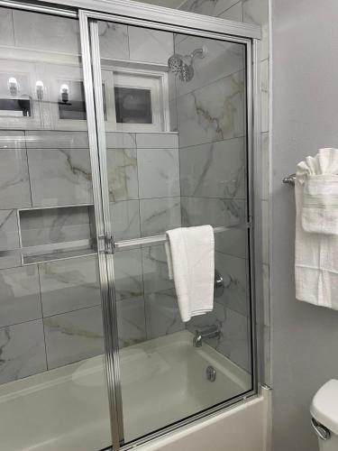 a bathroom with a shower with a glass at Paradise View- Oceanfront Oasis in Runaway Bay