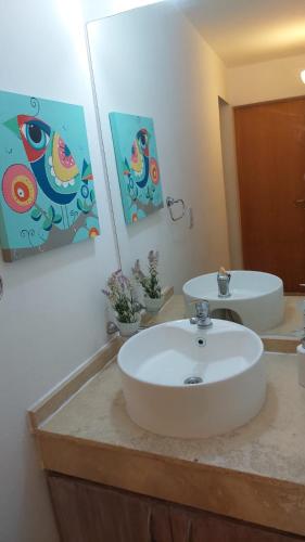 a bathroom with a white sink and a mirror at Mirasol in Villa Carlos Paz