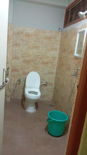 a bathroom with a toilet and a bucket at K2k homestsy in Rhenok