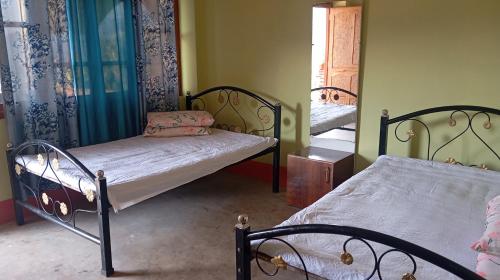 a bedroom with two beds and a window at K2k homestsy in Rhenok