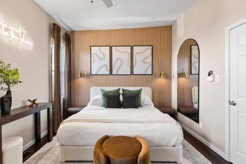 a bedroom with a large bed and a chair at The Bricklight | Elevated 3BR + Parking in Soulard in Saint Louis