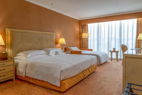 Lova arba lovos apgyvendinimo įstaigoje Similan Hotel Zhuhai-Gongbei Port