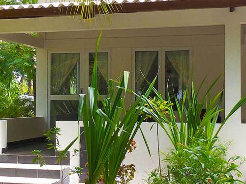 a front door of a house with some plants at Hotel Village Vacances Awale Plage in Grand-Popo