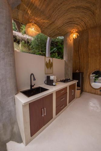 a kitchen with a sink and a counter at Lazy Coconut Bali in Gianyar