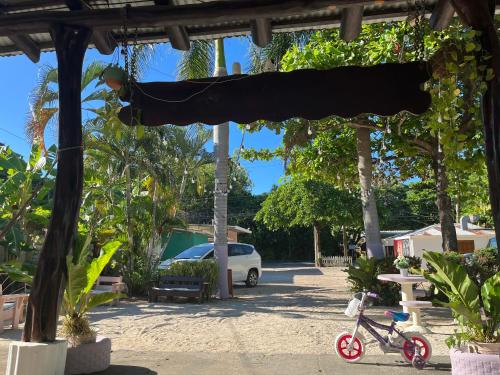 a car parked in a parking lot with a black covering at Her Waves & Wi-Fi Boutique Hotel in Tamarindo