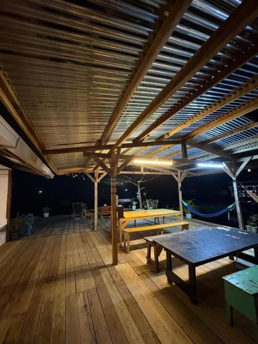 a wooden deck with tables and benches on a boat at Scuba Buddy Mabul Dive Lodge in Pulau Mabul 