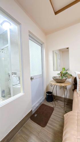 a bedroom with a bed and a window and a table at North House in Ấp Bình Trung