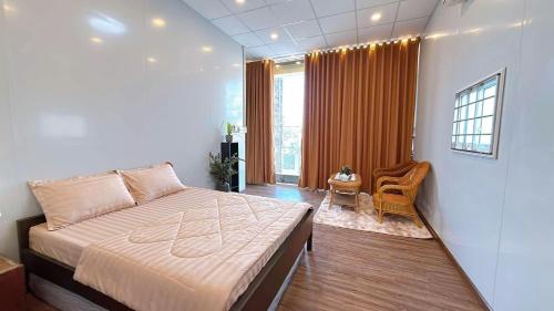 a bedroom with a bed and a table and a window at North House in Ấp Bình Trung