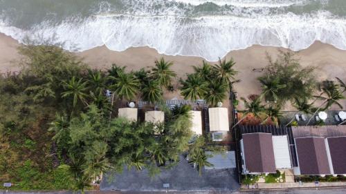 an aerial view of a beach with palm trees at Sichon Glamping Resort, Beachfront in Ban Plai Thon