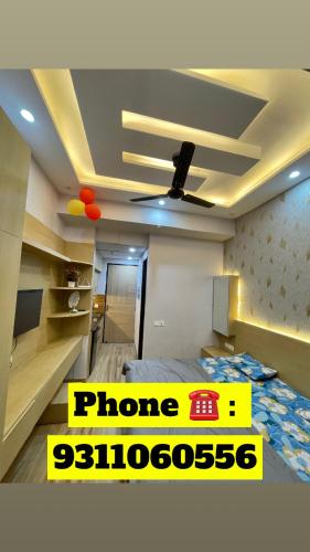 a room with a bed with a sign on it at Infinity Haven in Greater Noida