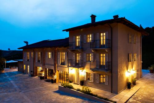a large building with lights on at Réva Resort in Monforte dʼAlba